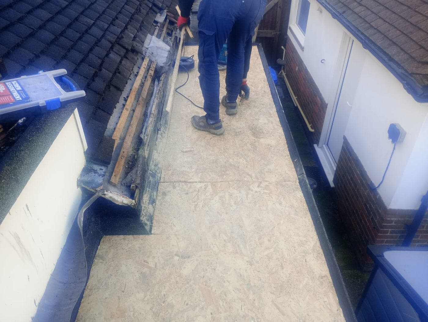 Our team laying a new flat roof deck